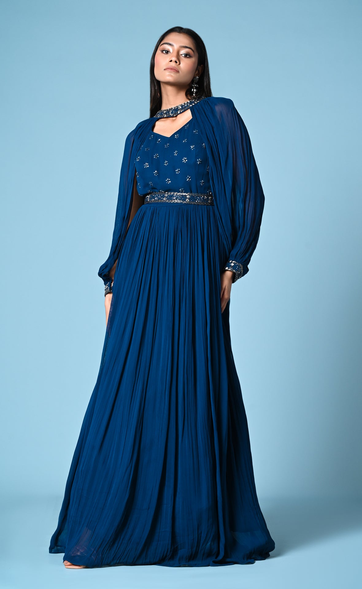 Peacock blue cocktail gown with statement sleeve and hip belt