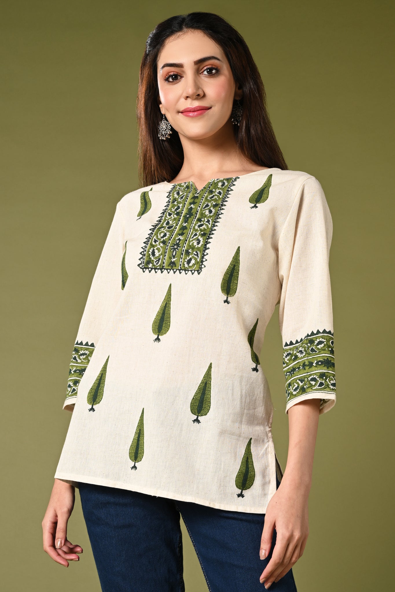 Half white short cotton flex summer kurthi for jean with green leaf prints.
•	Straight short cotton kurti with leaf prints all over.
•	Mild thread work in neck ,3/4 sleeves.
•	 Cotton flex material.
