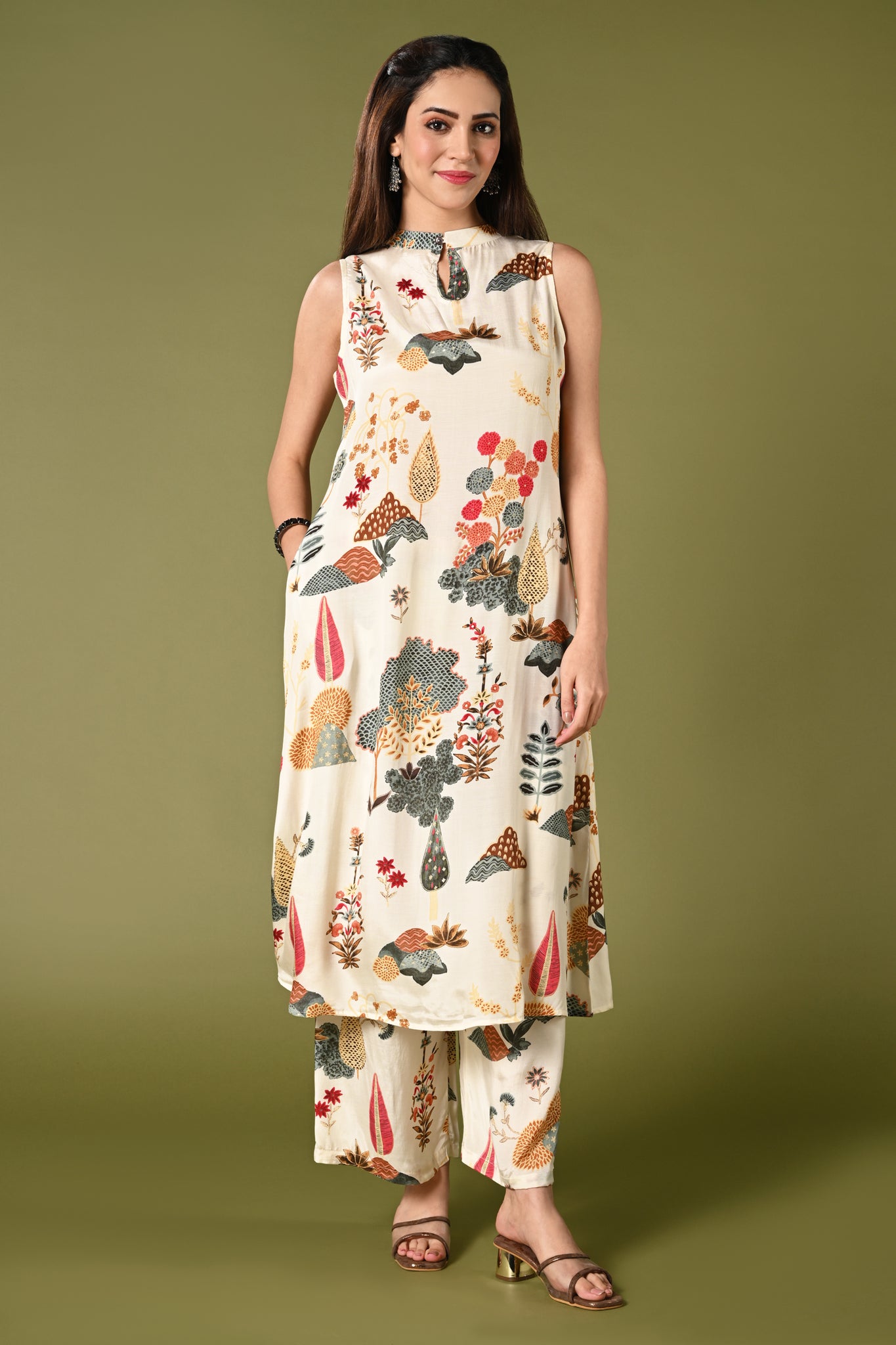 Off white printed coords set with high closed neck and matching wide leg pants.
•	Floral prints all over the top.
•	High close neck with button, sleeveless, sleeves comes separately with the top.
•	Matching printed bottom wide leg pants with double sided elastic.
•	Chanderi rayon material.
