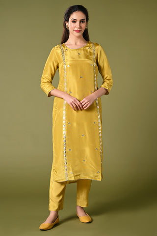 Pale mustard yellow shimmer fabric kurti set with floral printed organza dupatta, gotta patti work and straight pants.
•	Plain top with gotta patti work.
•	Round neck & 3/4 sleeves.
•	Single sided elastic and comfortable straight pants.
•	Floral printed organza dupatta with tassels.
•	Shimmer fabric material
•	The shimmer fabric with prints will give you a perfect occasional look.
