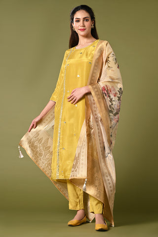 Pale mustard yellow shimmer fabric kurti set with floral printed organza dupatta, gotta patti work and straight pants.
•	Plain top with gotta patti work.
•	Round neck & 3/4 sleeves.
•	Single sided elastic and comfortable straight pants.
•	Floral printed organza dupatta with tassels.
•	Shimmer fabric material
•	The shimmer fabric with prints will give you a perfect occasional look.
