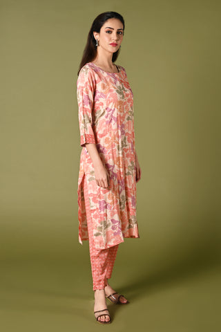 Peach floral printed daily wear rayon kurti set with 3/4 sleeves roundneck single side pocket and straight pants.
•	Floral prints all over the kurti set.
•	Round neck, 3/4 sleeves & single side pocket.
•	Double sided elastic straight fit pants.
•	All day comfort rayon material.
•	Peach colour with floral prints will give a warm look with the touch of freshness and elegance.
