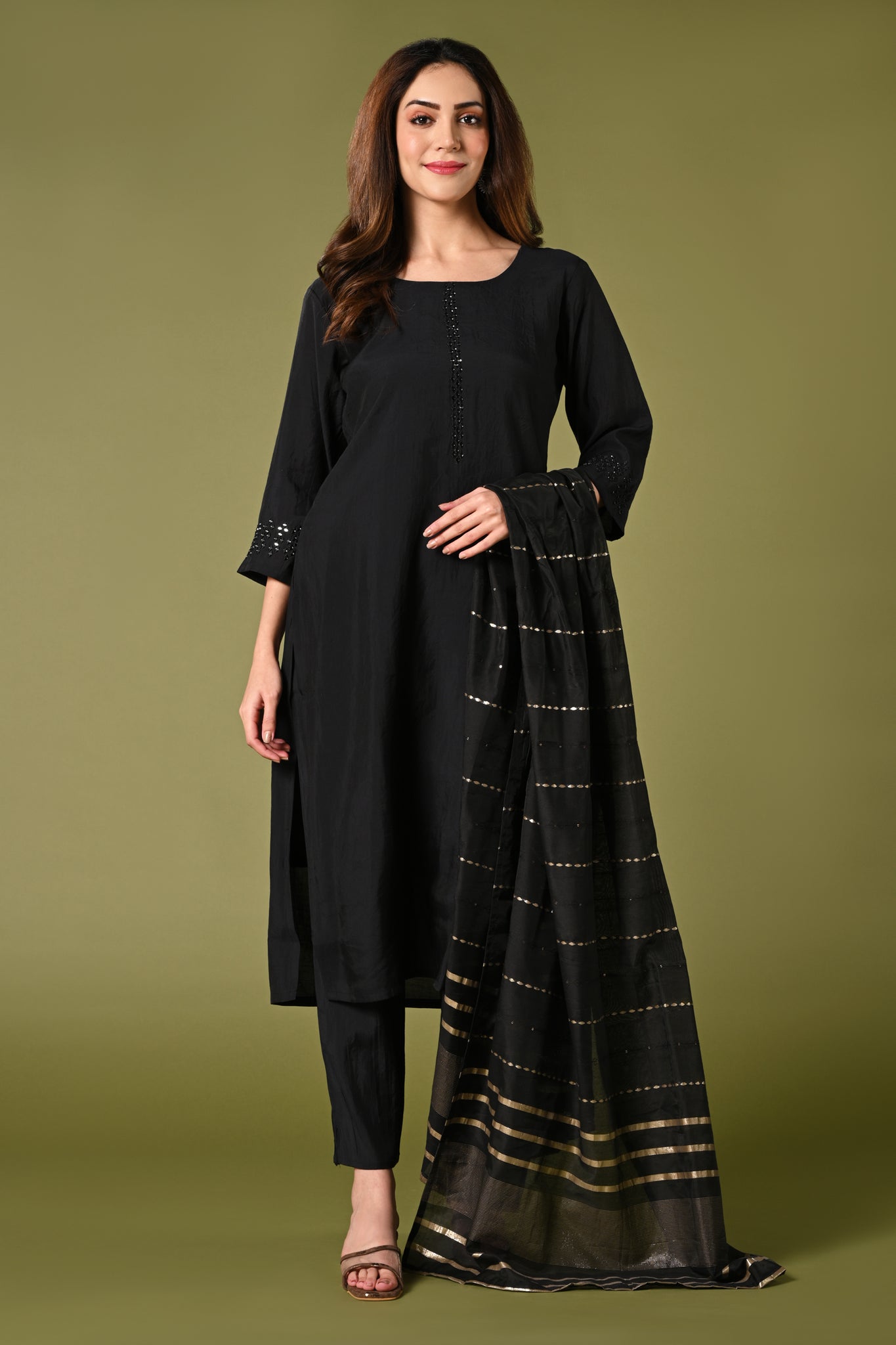 Plain black mirror worked straight cut set with zari woven dupatta and straight pants.
•	Plain top with mirror-work in neckline and back neck.
•	3/4 sleeves with mirror and thread work in border.
•	Single side elastic comfortable straight pants.
•	Matching black zari woven dupatta.
•	Chanderi material.
