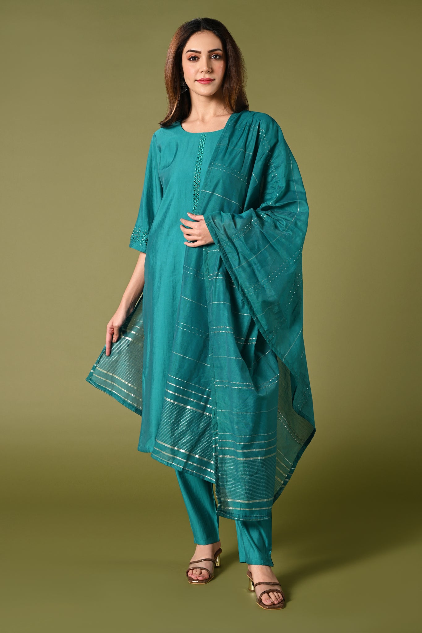 Plain blue mirror worked straight cut set with zari woven dupatta and straight pants.
•	Plain top with mirror-work in neckline and back neck.
•	3/4 sleeves with mirror and thread work in border.
•	Single side elastic comfortable straight pants.
•	Matching blue zari woven dupatta.
•	Chanderi material.
