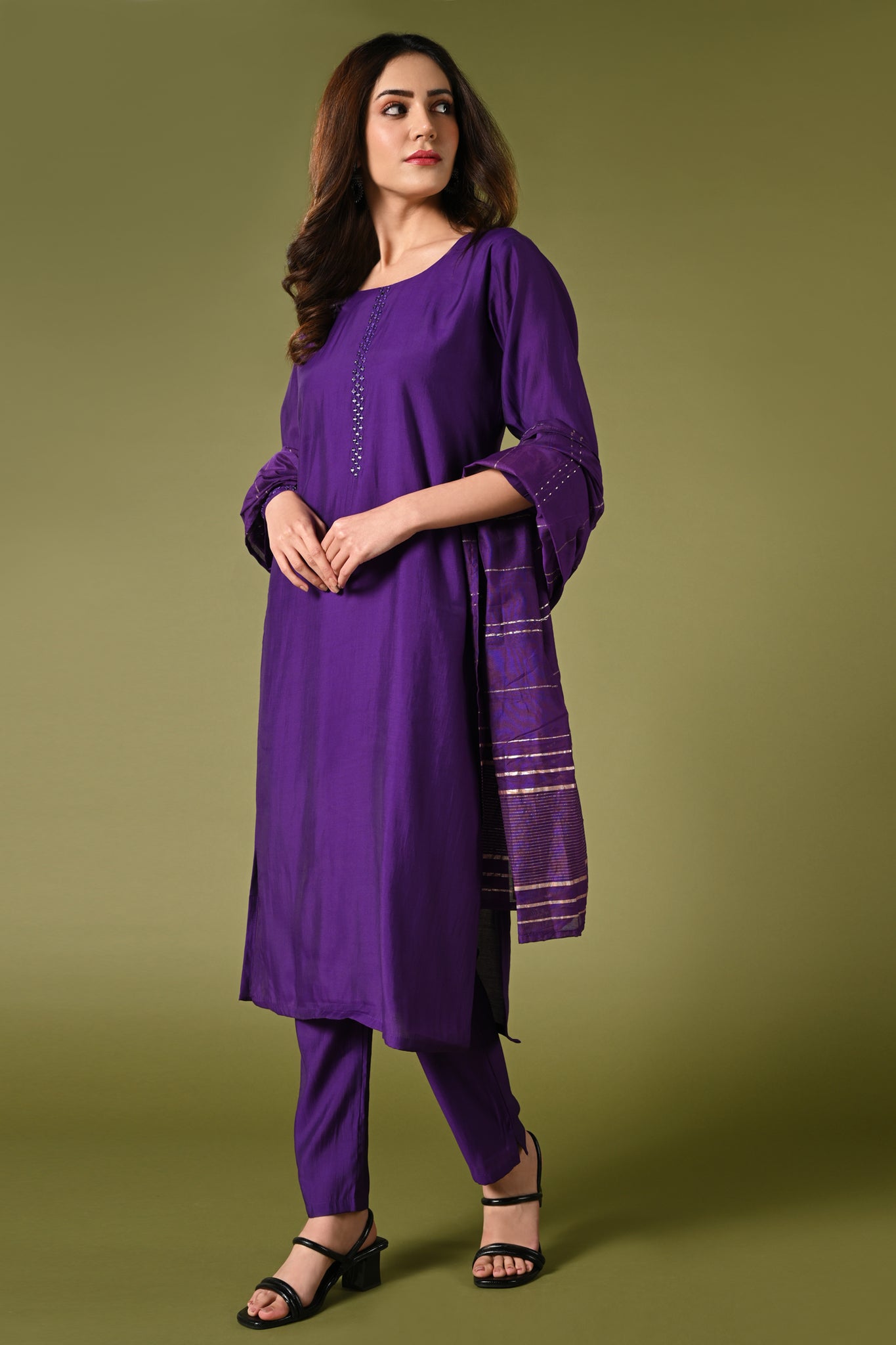 Plain purple mirror worked straight cut set with zari woven dupatta and straight pants.
•	Plain top with mirror-work in neckline and back neck.
•	3/4 sleeves with mirror and thread work in border.
•	Single side elastic comfortable straight pants.
•	Matching purple zari woven dupatta.
•	Chanderi material.
