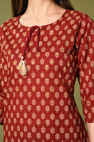 Printed maroon daily wear straight cotton kurti with mirror and thread work.
•	Straight kurti with prints all over.
•	3/4 sleeves, round neck with rope.
•	Mirror and thread work in the neck.
•	Pure cotton material.
