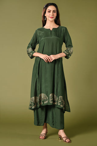 Solid green muslin kurti set with elephant print in border and sleeves.
•	Plain colour kurti with elephant prints in border and sleeve.
•	Round neck & 3/4 sleeves.
•	Double sided elastic and comfortable straight fit pants.
•	The green colour muslin with elephant prints will give a perfect occasional vibe.
