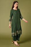 Solid green muslin kurti set with elephant print in border and sleeves.
•	Plain colour kurti with elephant prints in border and sleeve.
•	Round neck & 3/4 sleeves.
•	Double sided elastic and comfortable straight fit pants.
•	The green colour muslin with elephant prints will give a perfect occasional vibe.
