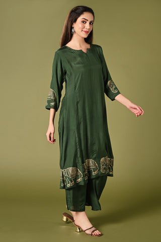 Solid green muslin kurti set with elephant print in border and sleeves.
•	Plain colour kurti with elephant prints in border and sleeve.
•	Round neck & 3/4 sleeves.
•	Double sided elastic and comfortable straight fit pants.
•	The green colour muslin with elephant prints will give a perfect occasional vibe.
