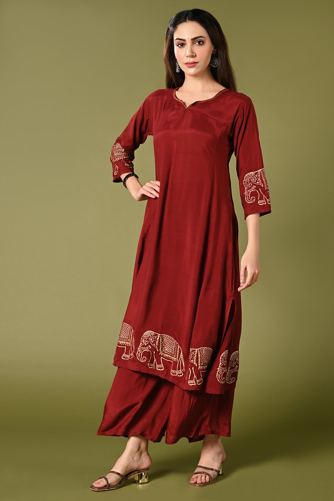  Solid maroon muslin kurti set with elepant print in border and sleeves.
•	Plain colour kurti with elephant prints in border and sleeve.
•	Round neck & 3/4 sleeves.
•	Double sided elastic and comfortable straight fit pants.
•	The marron colour muslin with elephant prints will give a elegant look with cultural touch.
