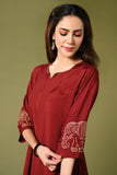  Solid maroon muslin kurti set with elepant print in border and sleeves.
•	Plain colour kurti with elephant prints in border and sleeve.
•	Round neck & 3/4 sleeves.
•	Double sided elastic and comfortable straight fit pants.
•	The marron colour muslin with elephant prints will give a elegant look with cultural touch.
