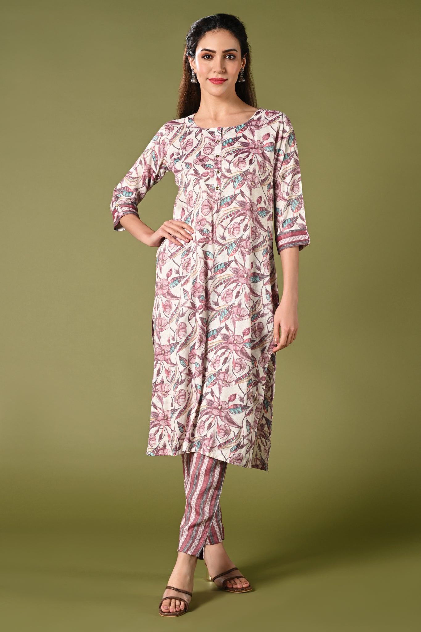 White and pink floral printed rayon daily wear kurti set with 3/4 sleeves roundneck single side pocket and straight pants.
•	Floral prints all over the kurti set
•	Round neck, 3/4 sleeves & single side pocket.
•	Double sided elastic straight fit pants.
•	All day comfort rayon material.
•	White and pink with floral prints will give a balanced and harmonious look.
