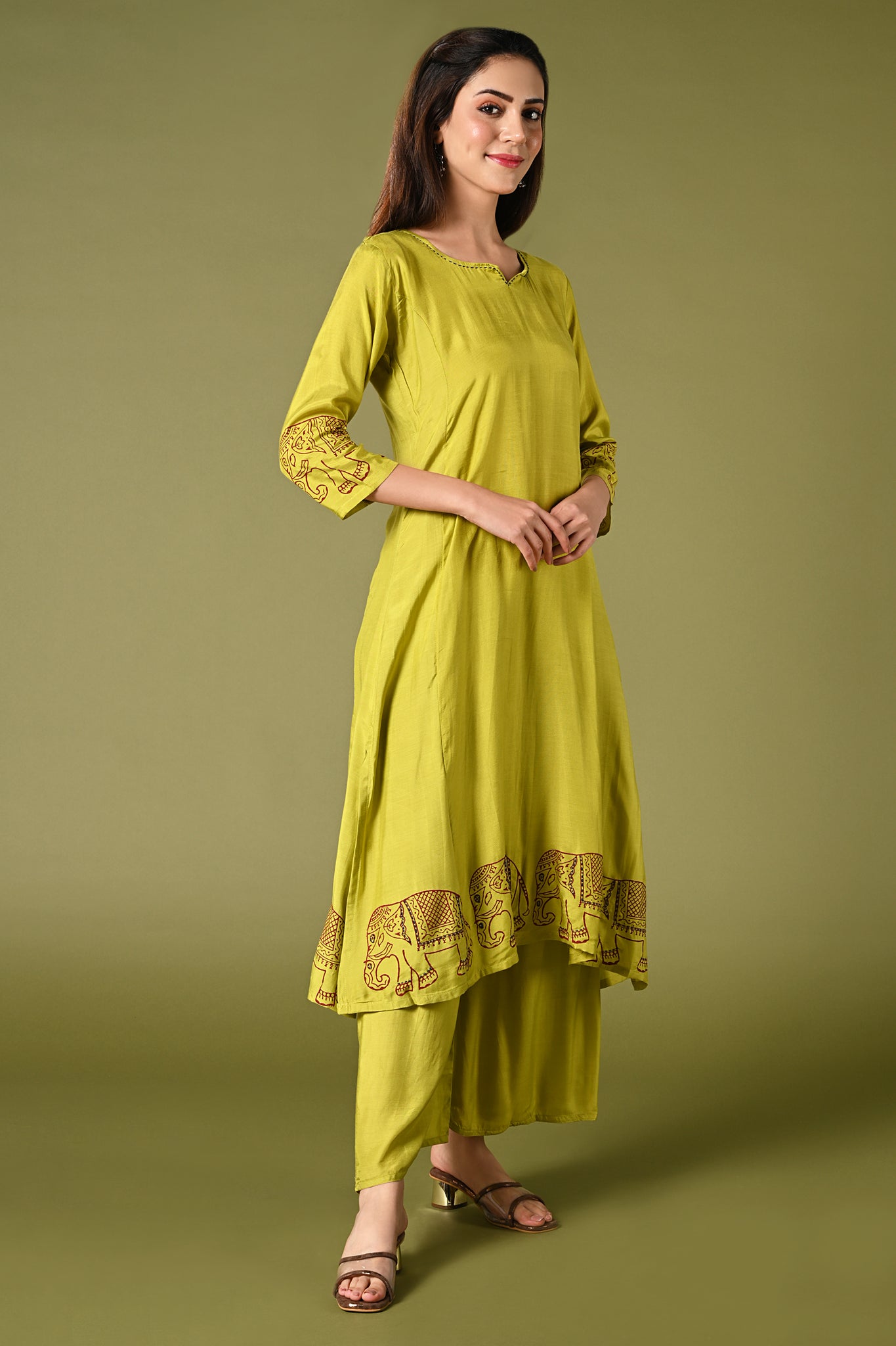 solid lime green muslin kurti set with elephant print in border and sleeves.
•	Plain color kurti with elephant prints in border and sleeve.
•	Round neck & 3/4 sleeves.
•	Double sided elastic and comfortable straight fit pants.
•	The lime green color muslin with elephant prints will give a fresh whimsical vibe.
