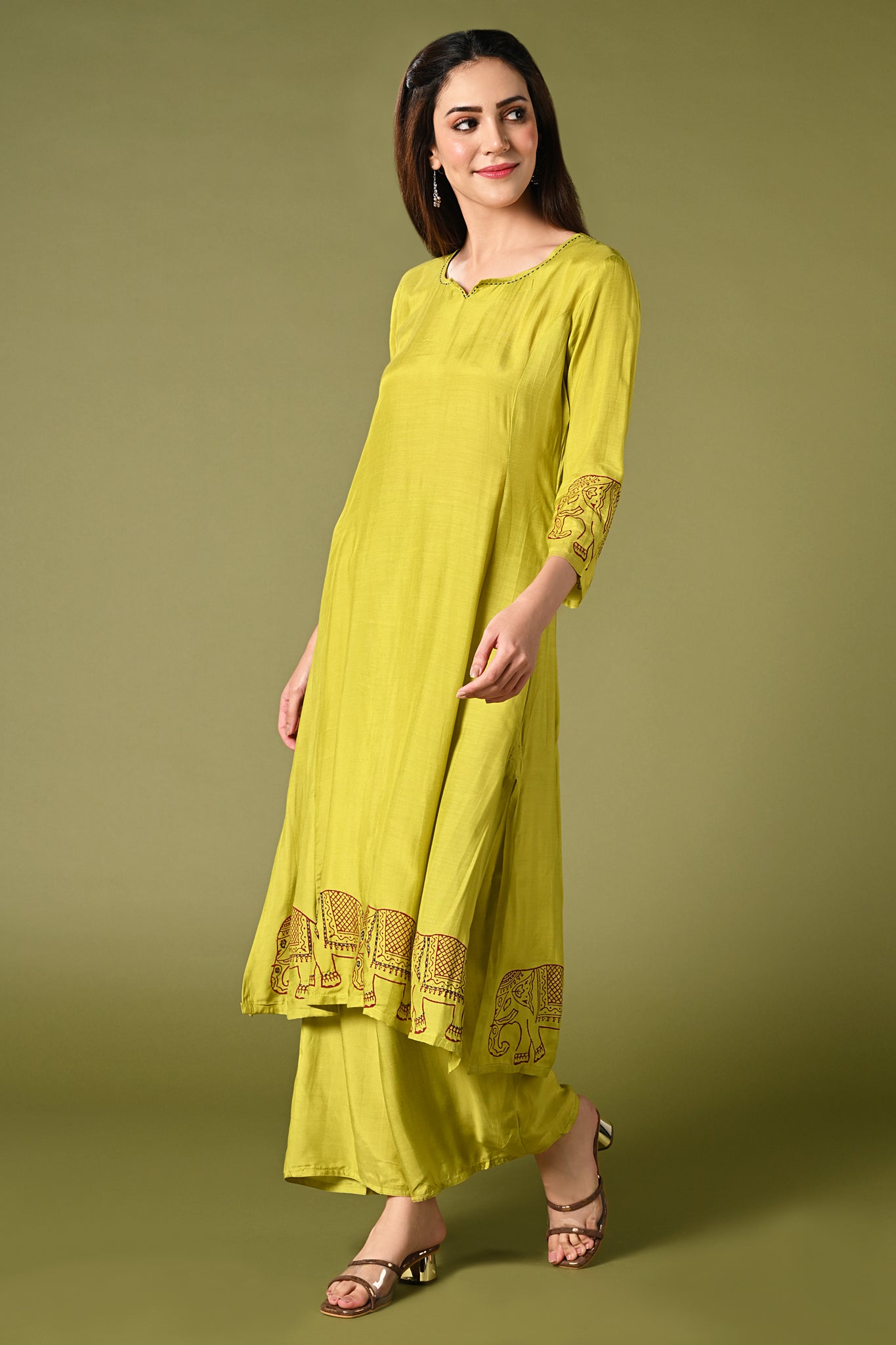 solid lime green muslin kurti set with elephant print in border and sleeves.
•	Plain color kurti with elephant prints in border and sleeve.
•	Round neck & 3/4 sleeves.
•	Double sided elastic and comfortable straight fit pants.
•	The lime green color muslin with elephant prints will give a fresh whimsical vibe.
