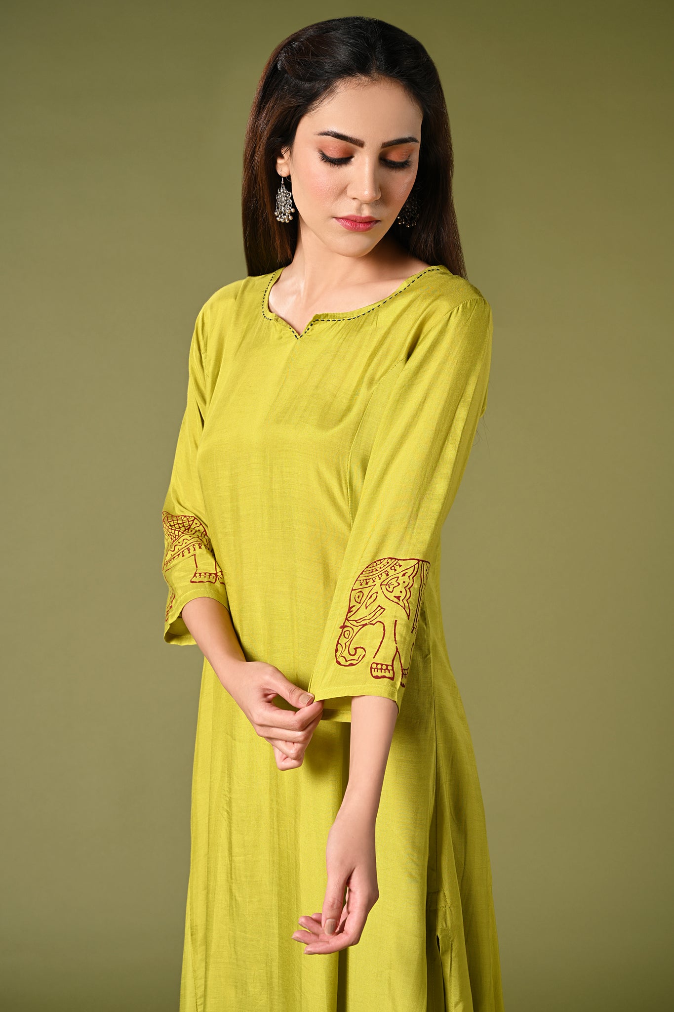 solid lime green muslin kurti set with elephant print in border and sleeves.
•	Plain color kurti with elephant prints in border and sleeve.
•	Round neck & 3/4 sleeves.
•	Double sided elastic and comfortable straight fit pants.
•	The lime green color muslin with elephant prints will give a fresh whimsical vibe.
