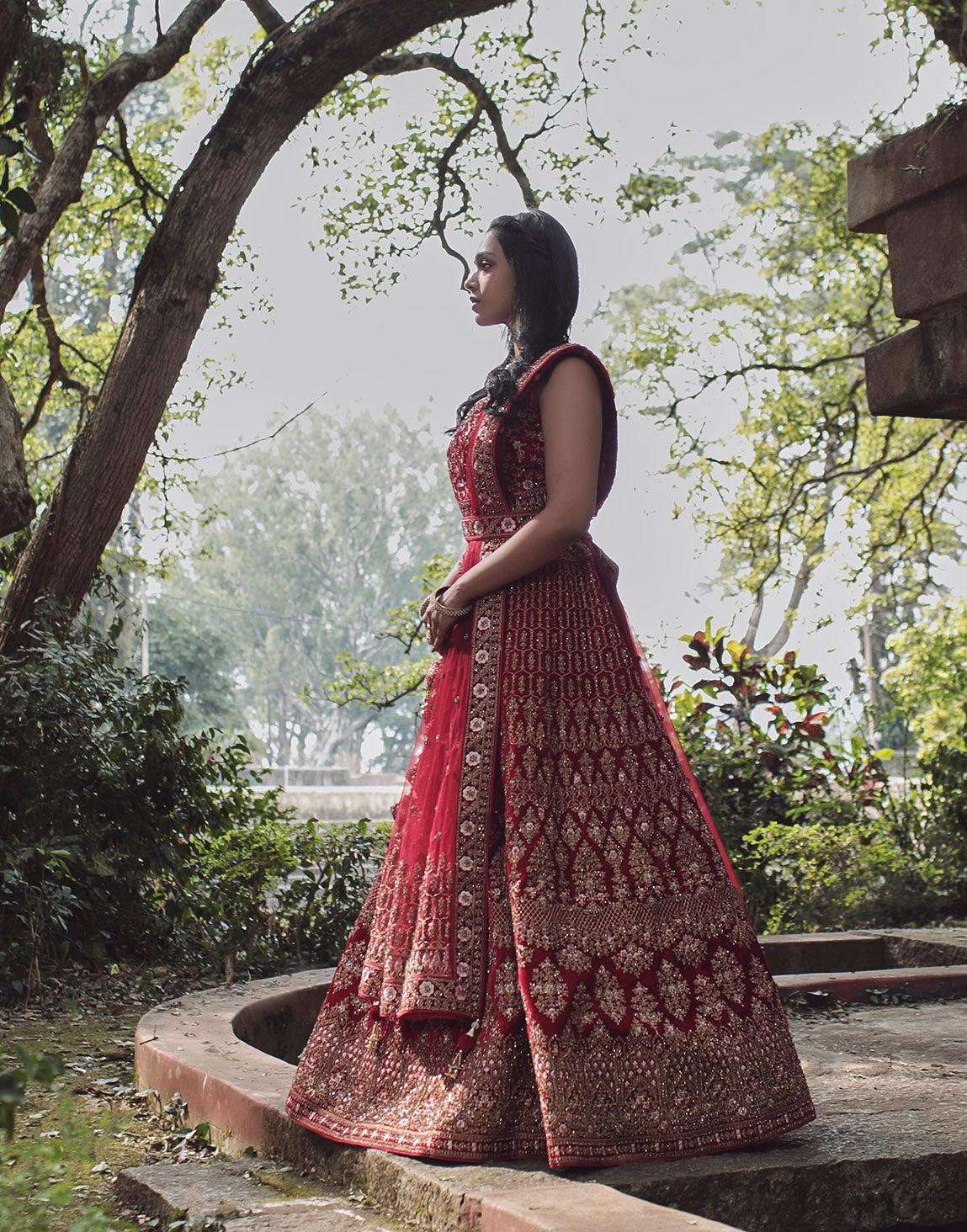 Red heavy worked bridal lehenga with belt and tassels